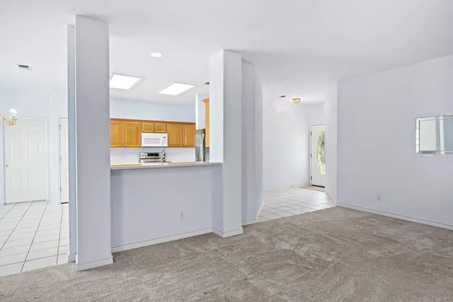 an empty room with a bathroom and mirror