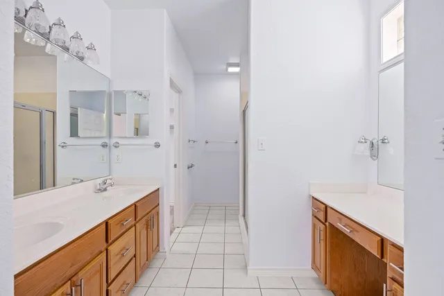 a spacious bathroom with a sink a mirror and a shower