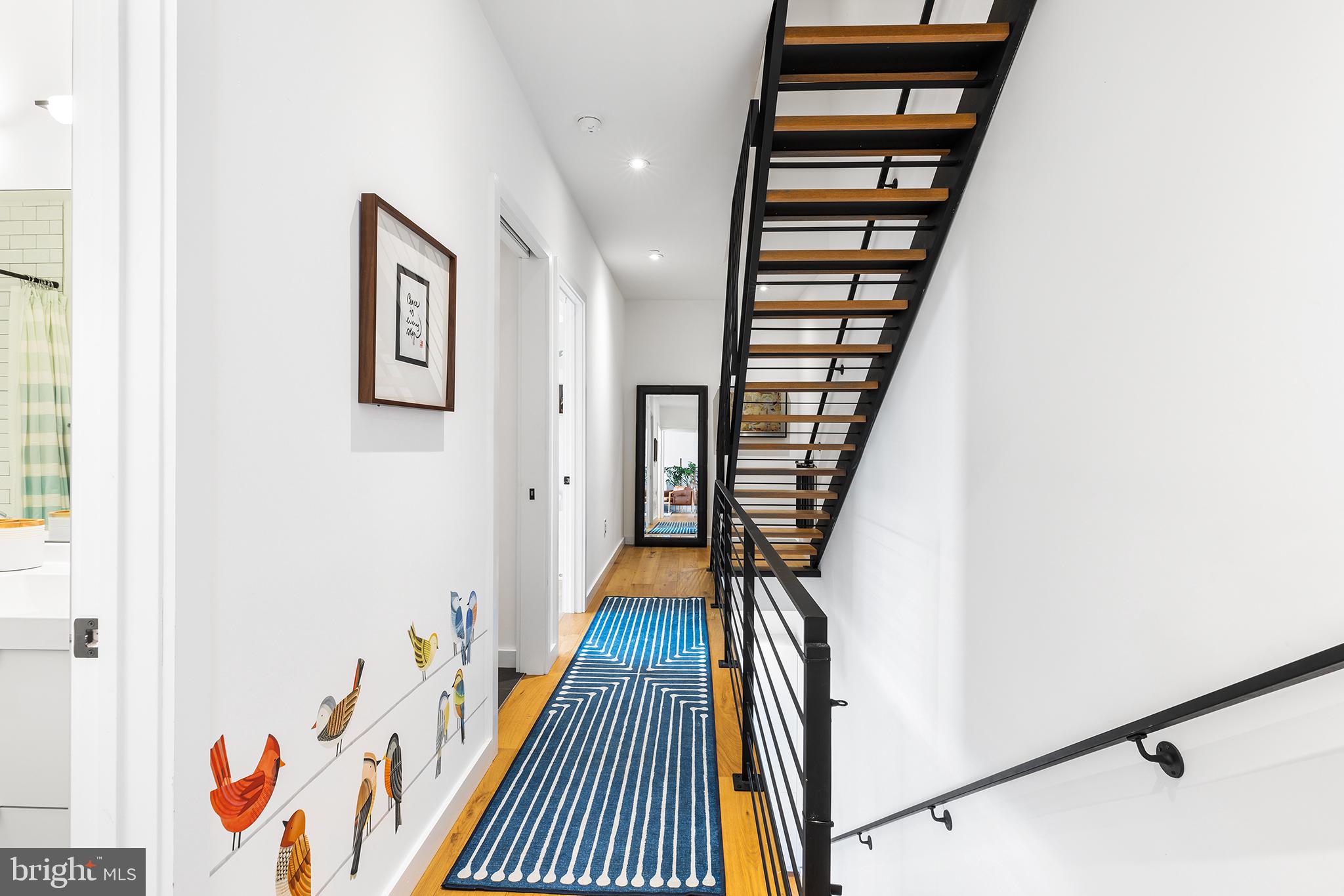 1124 Shackamaxon Street, Unit 8 Philadelphia, PA 19125 - Photo 18 of 41 a view of a hallway with wooden floor and staircase
