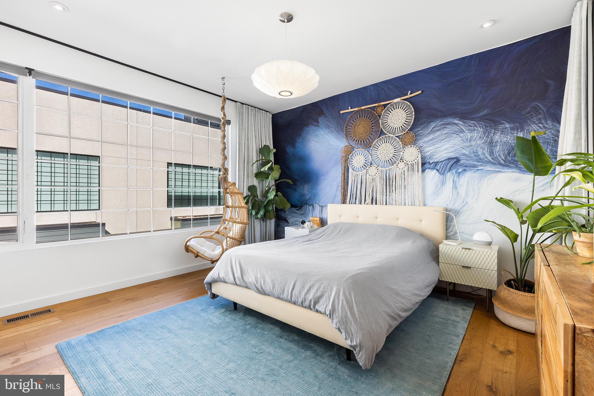 1124 Shackamaxon Street, Unit 8 Philadelphia, PA 19125 - Photo 23 of 41 a bedroom with a bed lamp and a potted plant