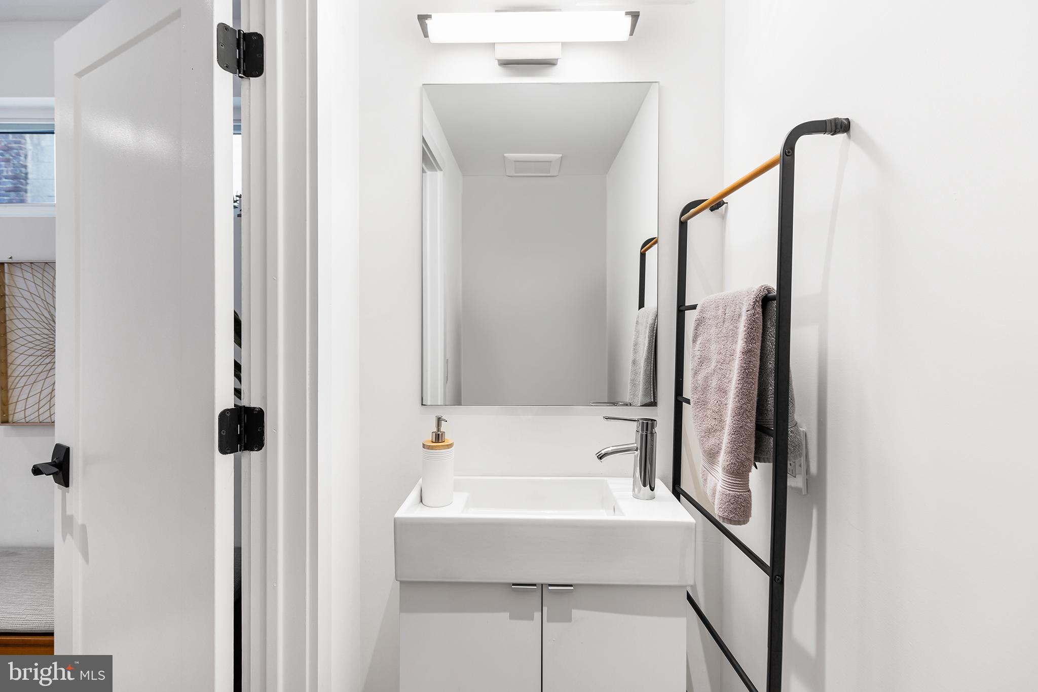 1124 Shackamaxon Street, Unit 8 Philadelphia, PA 19125 - Photo 5 of 41 a bathroom with a sink a mirror and a bathtub
