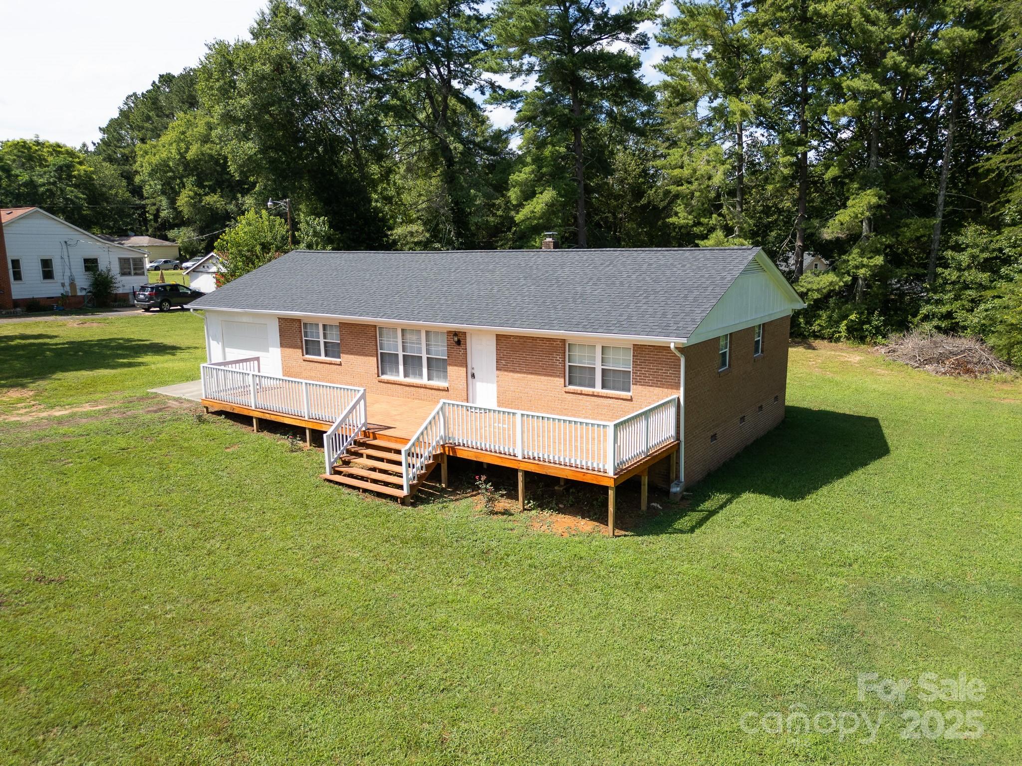 584 Southside Church Road Lincolnton, NC 28092 - Photo 1 of 28 a aerial view of a house with a yard table and chairs in patio