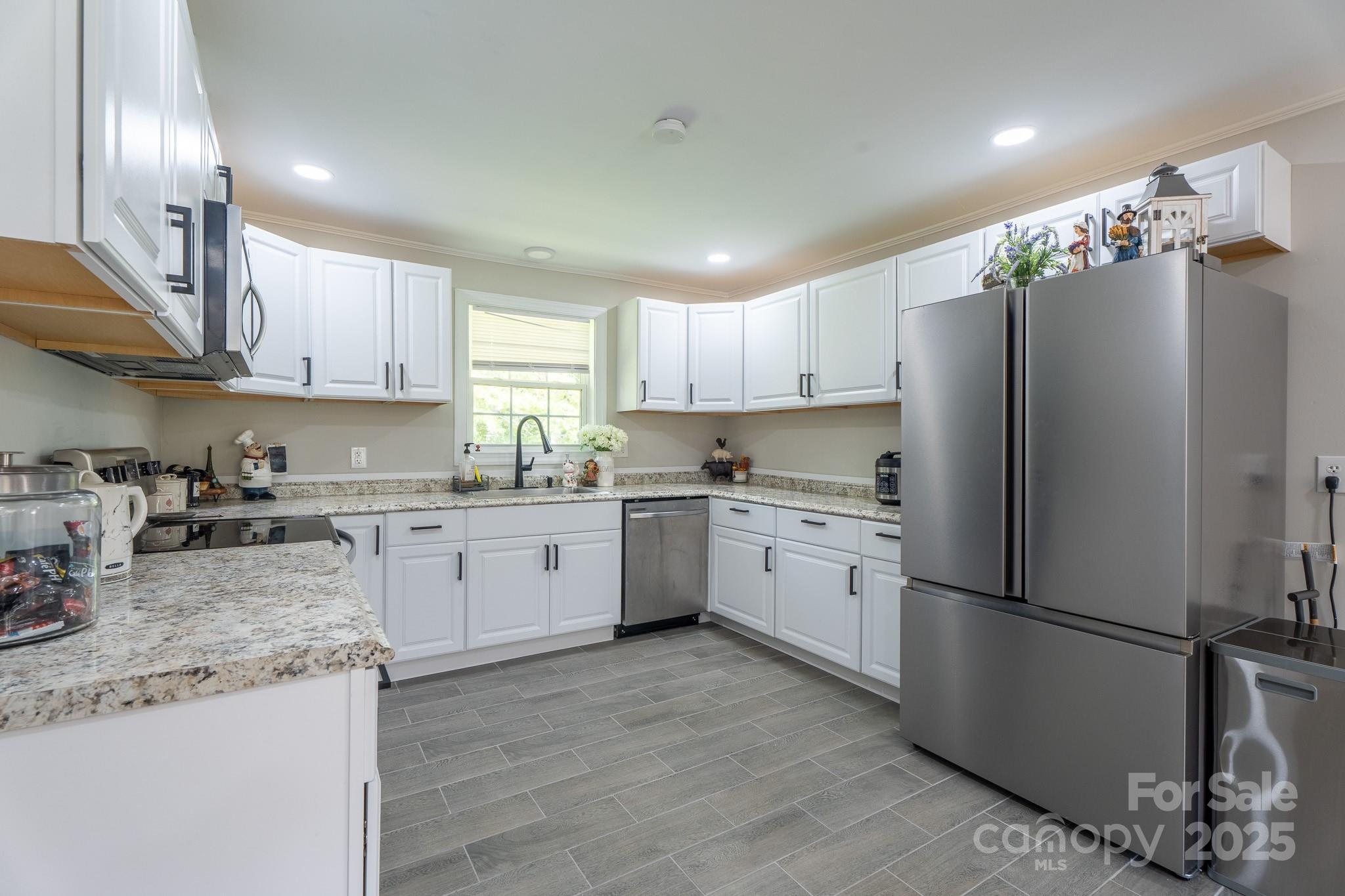 584 Southside Church Road Lincolnton, NC 28092 - Photo 4 of 28 a kitchen with granite countertop stainless steel appliances a refrigerator a sink a stove a microwave and cabinets