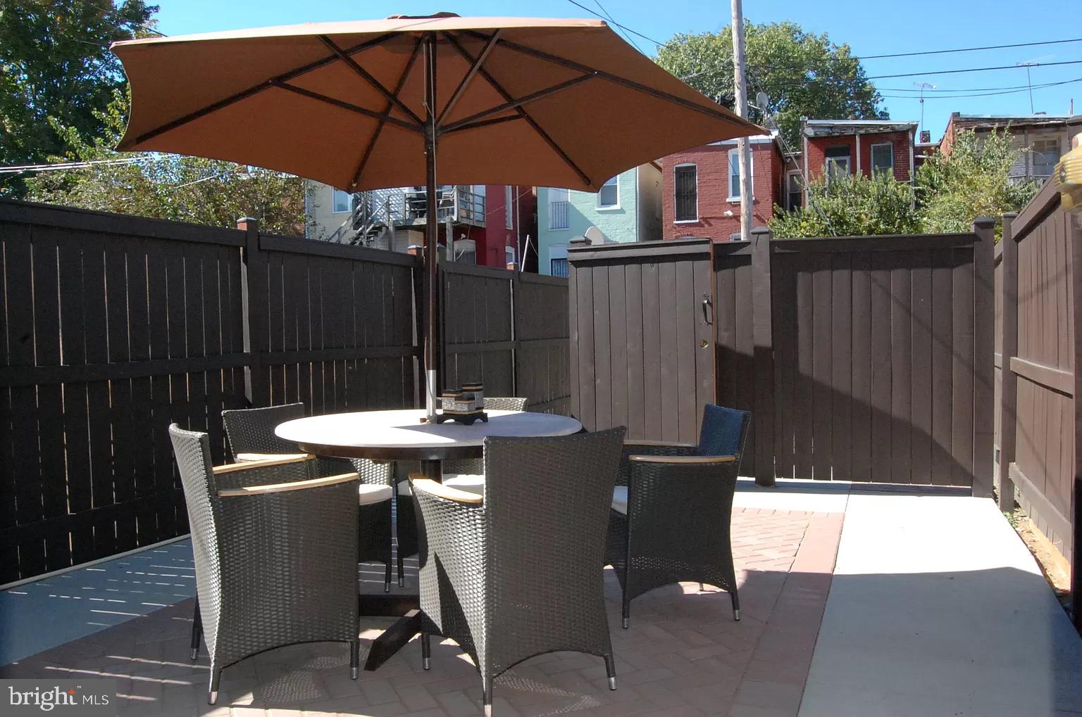 624 14th Place Northeast Washington, DC 20002 - Photo 19 of 22 a patio with wooden floor a yard a table and chairs