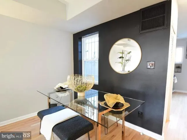 a dining room with furniture and a mirror