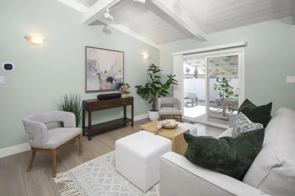 a living room with furniture and a painting on the wall