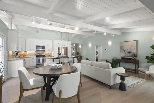 a living room with furniture and a dining table with kitchen view