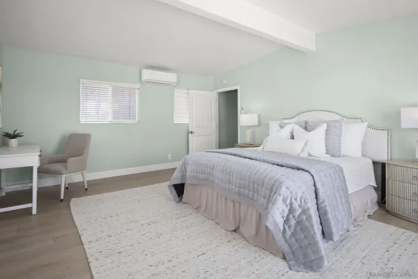 a bedroom with a bed and a chair