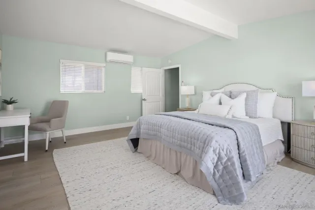 a bedroom with a bed and a chair