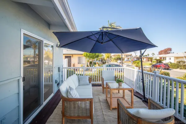 a view of balcony with furniture and umbrella