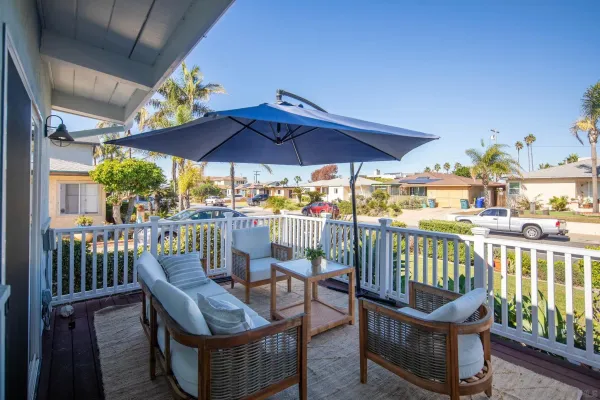 a view of a chairs and table in the balcony