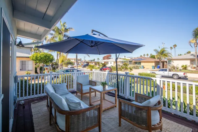 a view of a chairs and table in the balcony