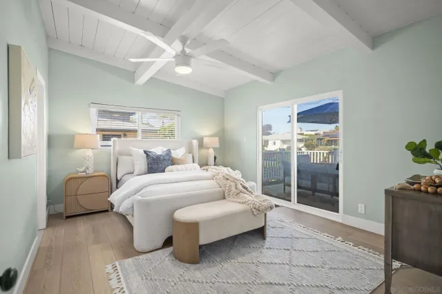 a spacious bedroom with a bed and glass door