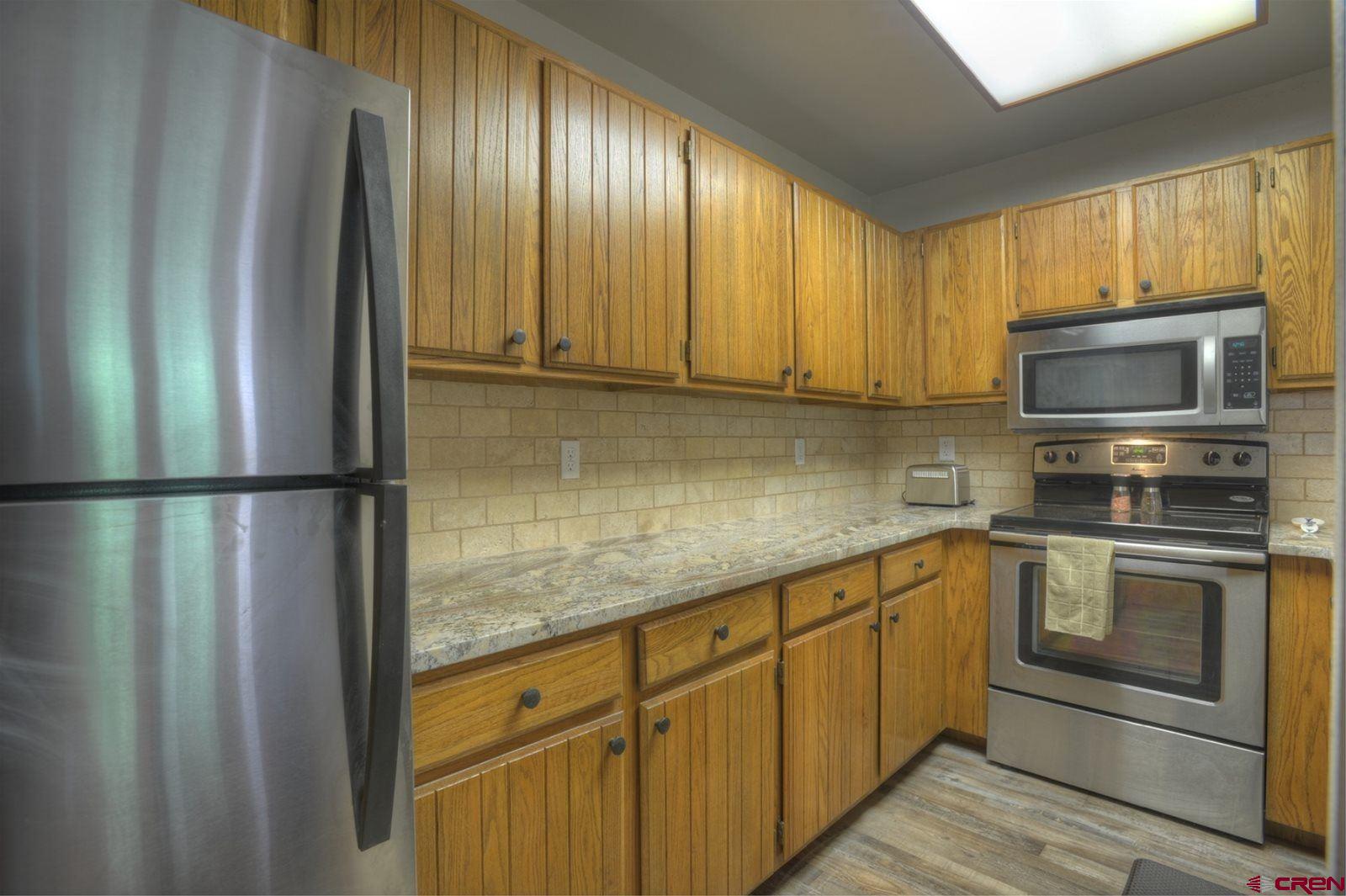6 Ferringway Circle, Unit 50 Durango, CO 81301 - Photo 19 of 30 a kitchen with stainless steel appliances granite countertop a refrigerator and a sink