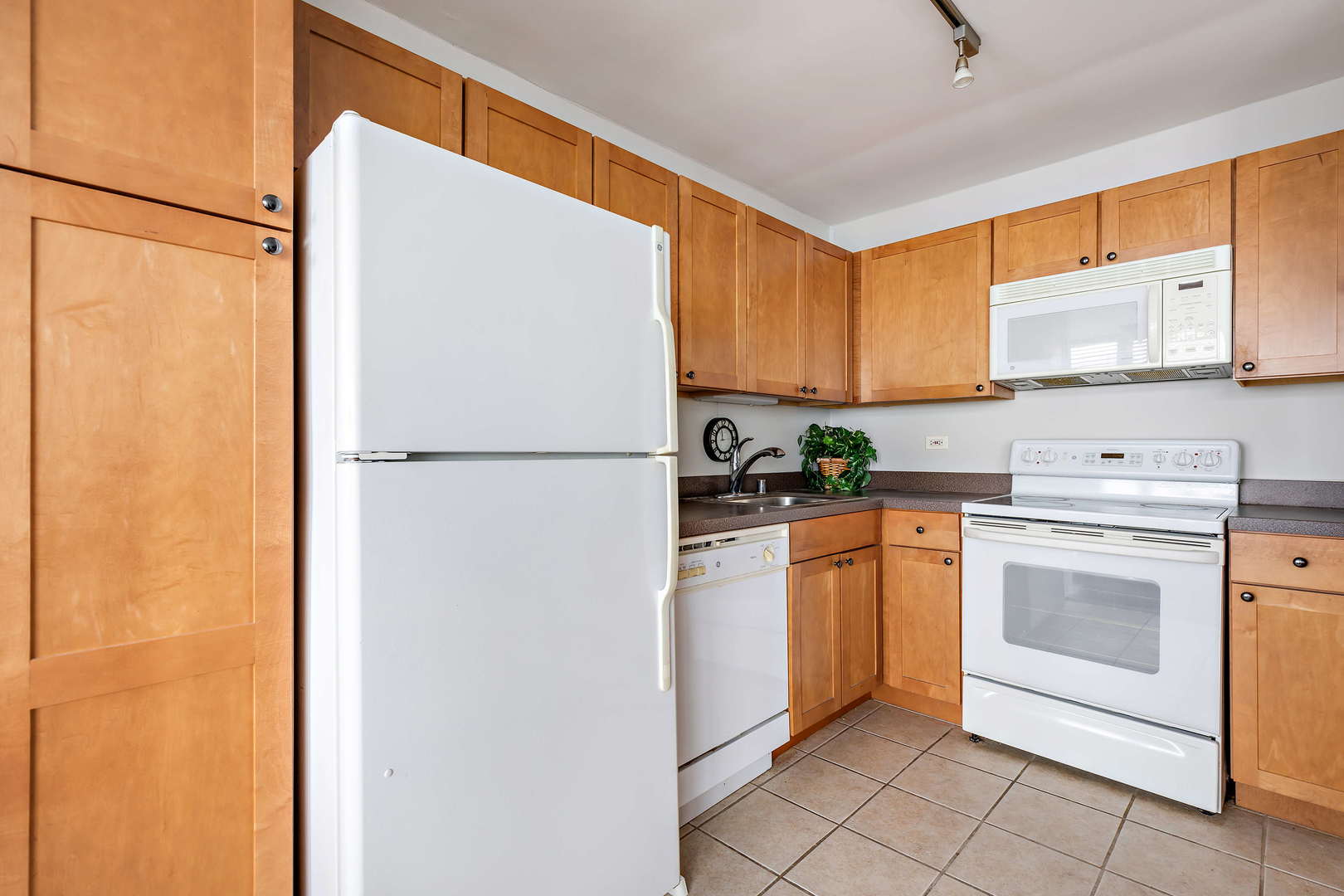 655 West Irving Park Road, Unit 4103 Chicago, IL 60613 - Photo 11 of 25 a kitchen with a refrigerator sink stove and cabinets