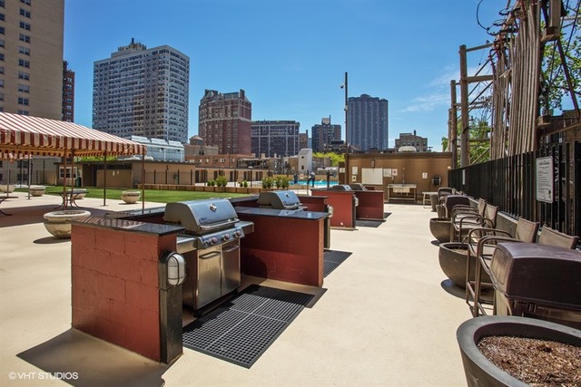 655 West Irving Park Road, Unit 4103 Chicago, IL 60613 - Photo 24 of 25 a living room with furniture a city view and a potted plant