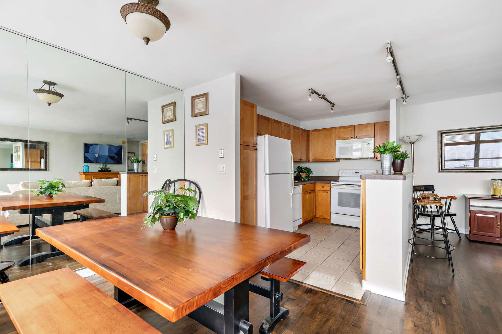 655 West Irving Park Road, Unit 4103 Chicago, IL 60613 - Photo 7 of 25 a living room with dining table and wooden floor