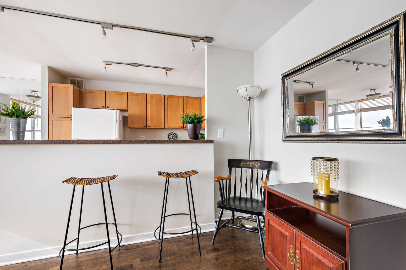 655 West Irving Park Road, Unit 4103 Chicago, IL 60613 - Photo 10 of 25 a kitchen with stainless steel appliances granite countertop a table chairs and a refrigerator