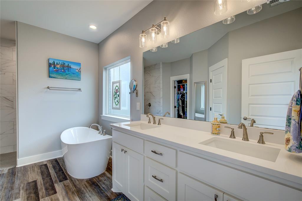 326 Koby Circle Sulphur Springs, TX 75482 - Photo 22 of 38 Primary bath has quartz countertops, free-standing soaking tub, and huge walk-in tiled shower with built-in bench