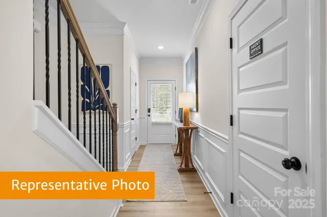 a view of a hallway with wooden floor and staircase