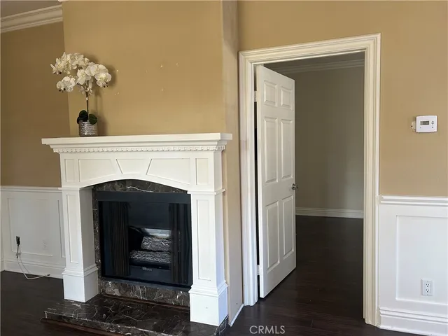 a living room with a fireplace and wooden floor