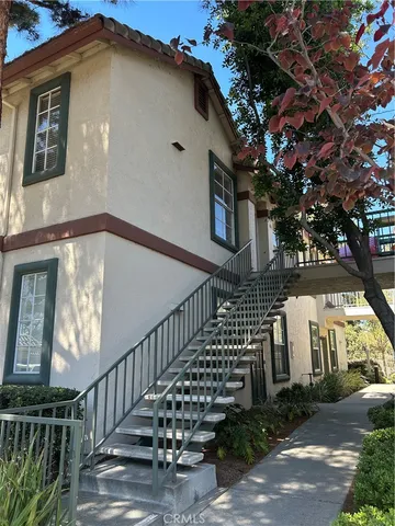 a view of a house with wooden fence