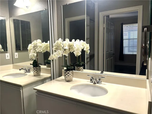 a bathroom with a sink double vanity and a mirror