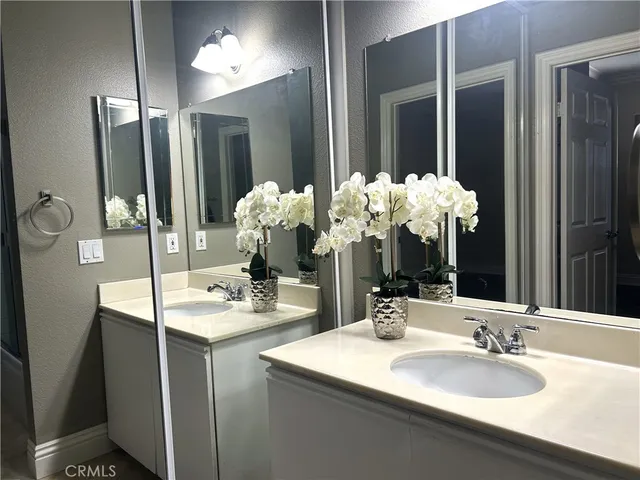 a bathroom with a sink vanity and a mirror