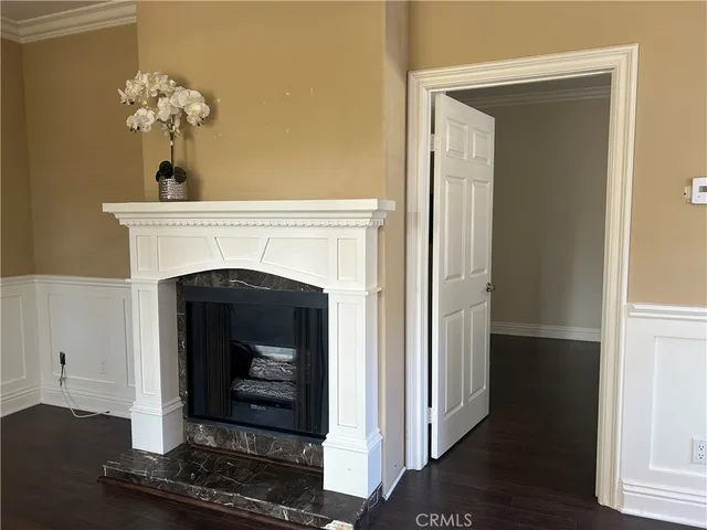 a living room with a fireplace and wooden floor