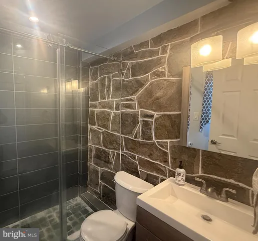a bathroom with a sink toilet and shower
