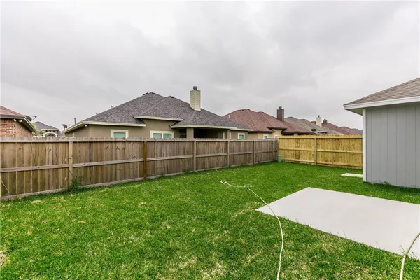 a view of a backyard with a garden and deck