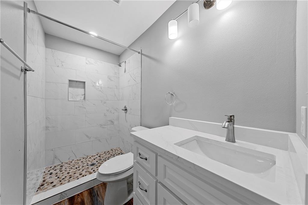 3412 North 24th Street Waco, TX 76708 - Photo 11 of 15 a bathroom with a sink toilet and shower