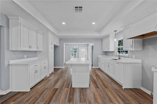 a large white kitchen with cabinets