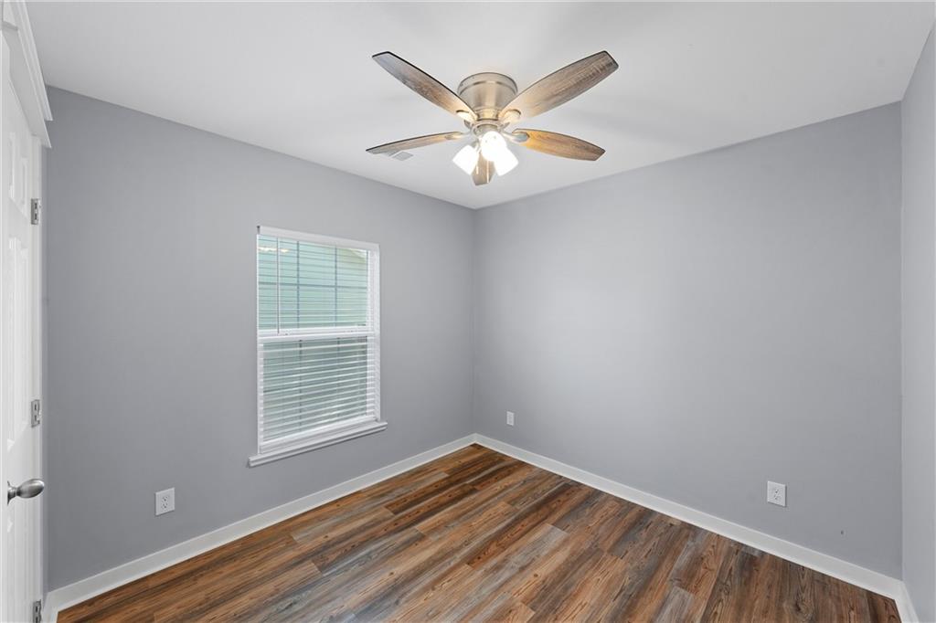 3412 North 24th Street Waco, TX 76708 - Photo 10 of 15 an empty room with wooden floor fan and windows