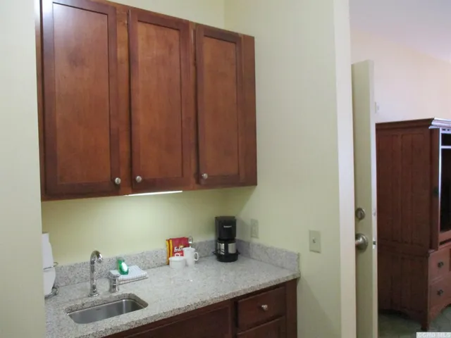 a kitchen with a sink cabinets and utility room