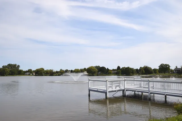 a view of a lake with table and chairs