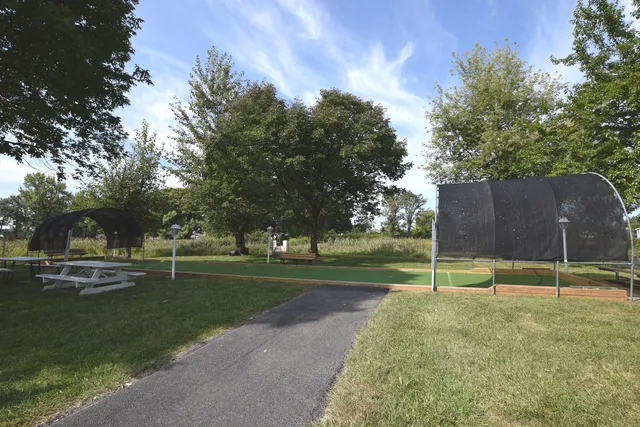 a backyard of house with trees and sign board