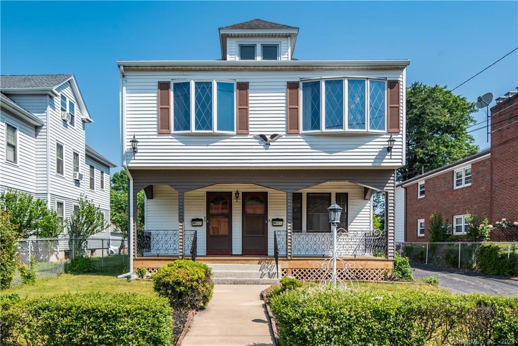 46-48 Victoria Road Hartford, CT 06114 - Photo 1 of 1 a front view of a house with a yard