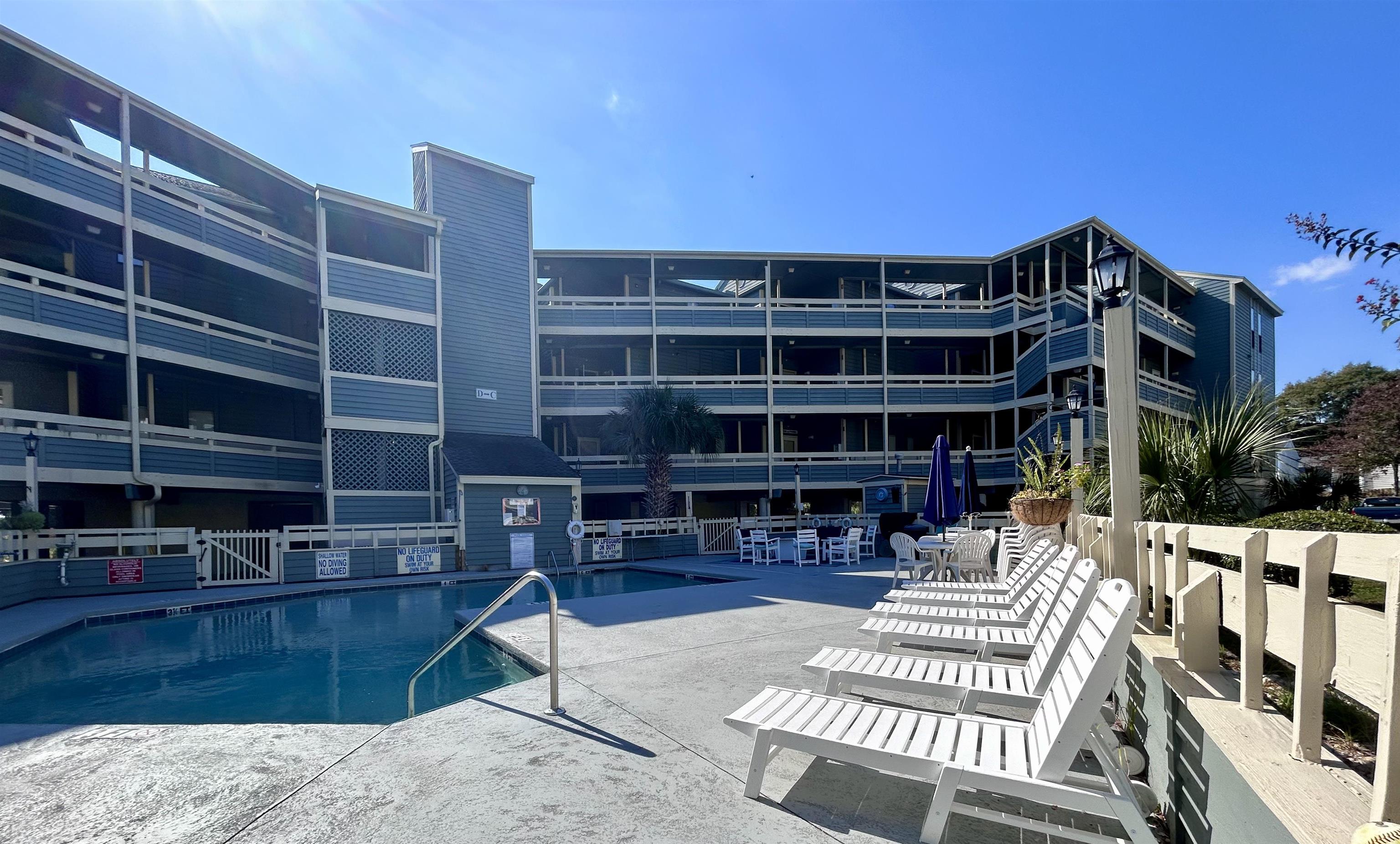 1101 Possum Trot Road, Unit B302 North Myrtle Beach, SC 29582 - Photo 3 of 22 View of swimming pool featuring a patio area