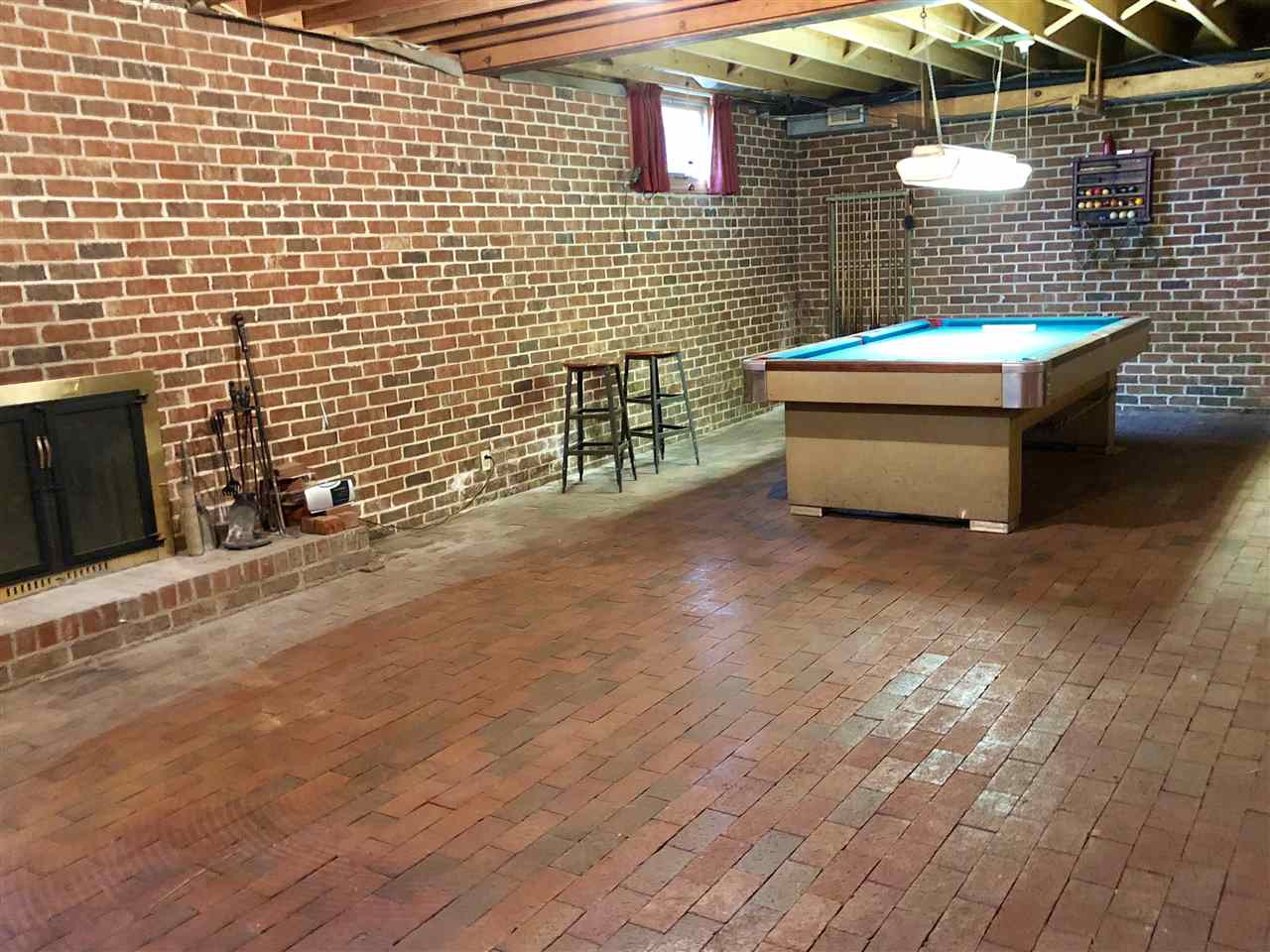 2717 Riddick Drive Raleigh, NC 27609 - Photo 9 of 13 Full basement has brick floors! Large room with pool table, wood-burning fireplace. There is a second large room, bedroom, full bath, workshop Basement