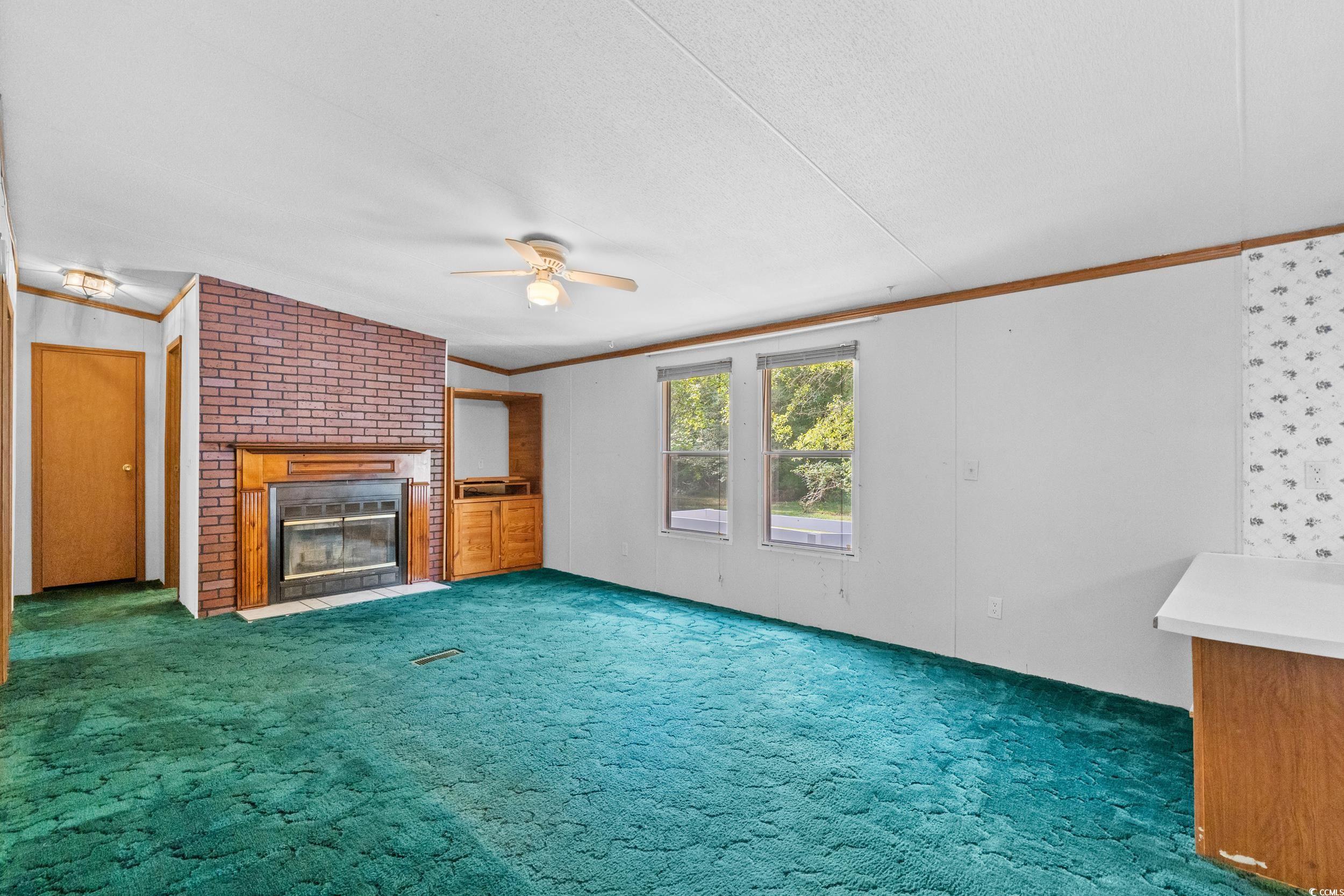 1731 Mineral Springs Road Conway, SC 29527 - Photo 16 of 38 Unfurnished living room featuring a fireplace, cei