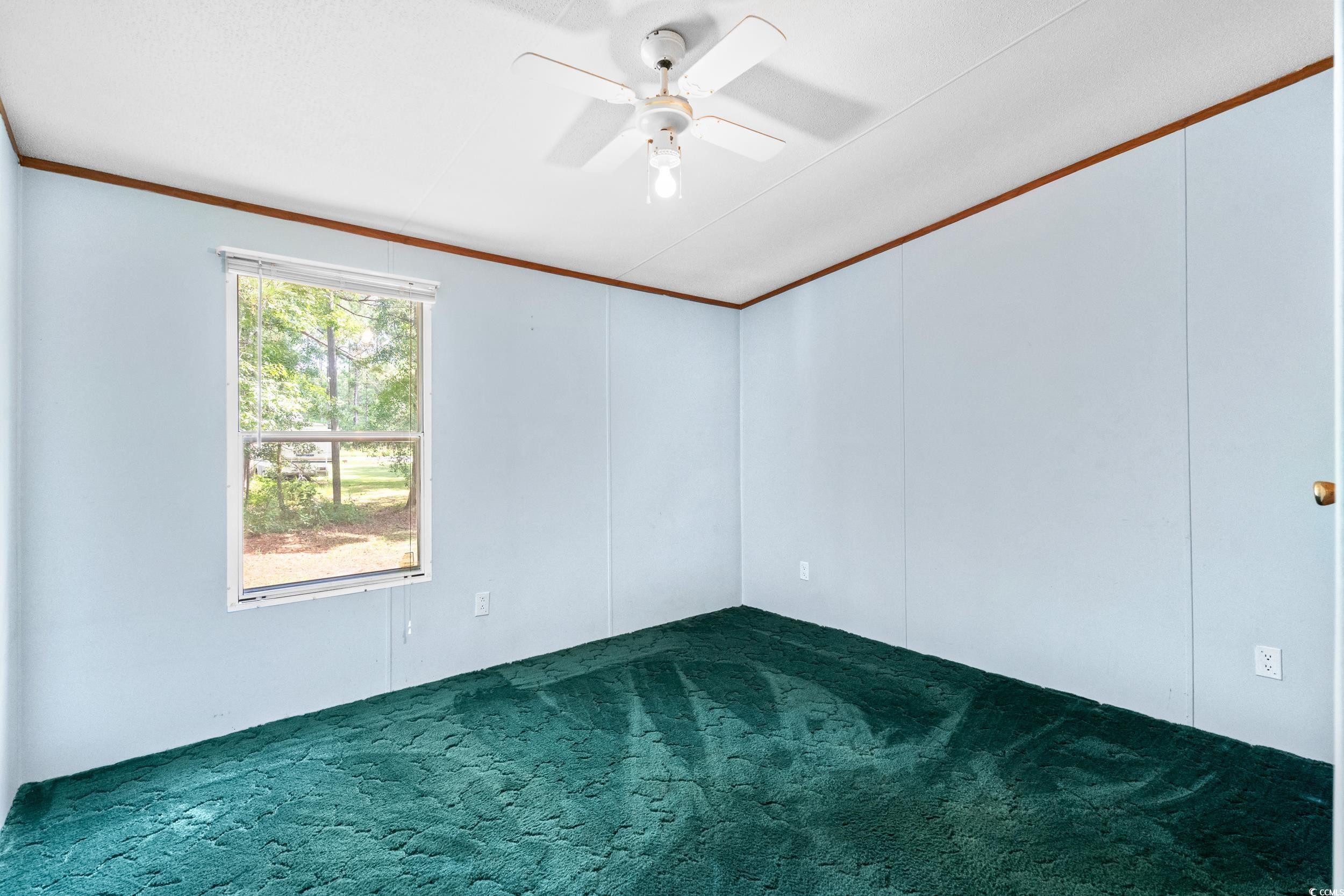 1731 Mineral Springs Road Conway, SC 29527 - Photo 29 of 38 Carpeted empty room with crown molding and ceiling