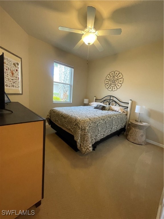 21326 Bella Terra Boulevard Estero, FL 33928 - Photo 11 of 47 a bedroom with a bed and a chandelier