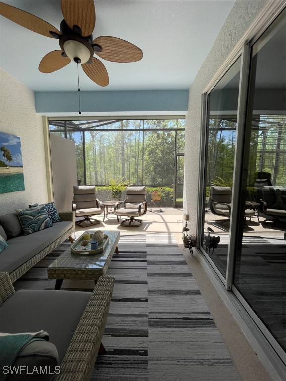 21326 Bella Terra Boulevard Estero, FL 33928 - Photo 36 of 47 a view of a patio with a dining table chairs barbeque grill with a floor to ceiling window