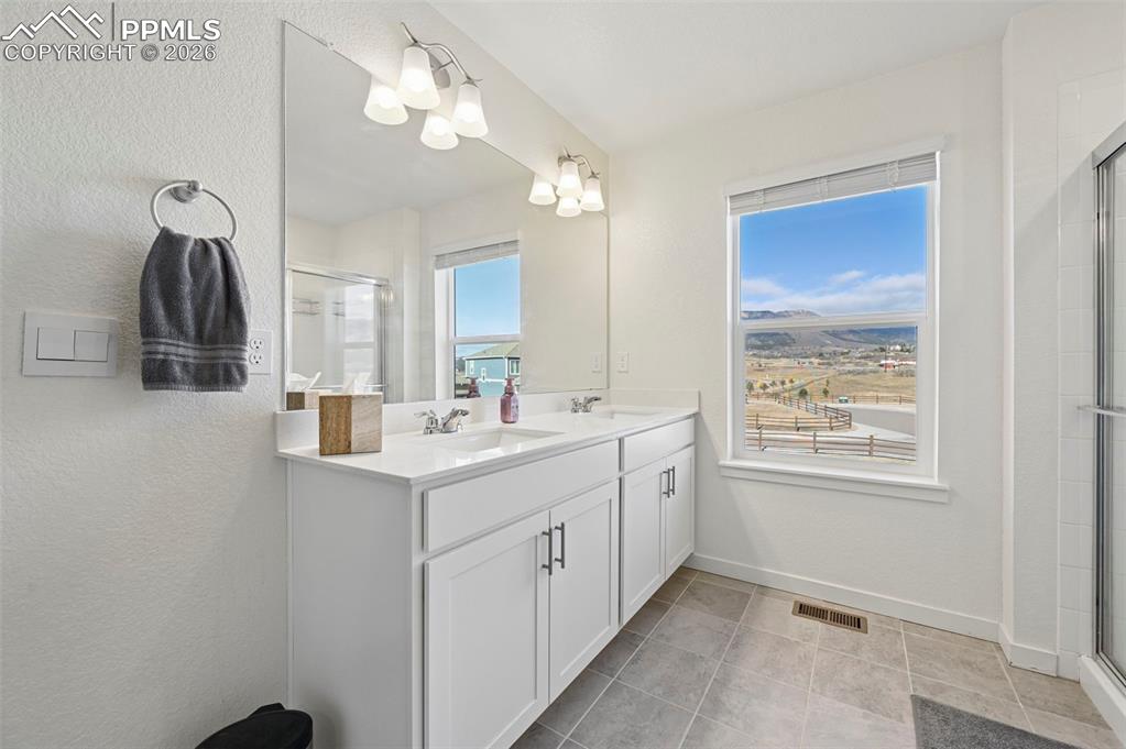 15945 Little Bluestem Road Monument, CO 80132 - Photo 14 of 49 a bathroom with a sink a vanity and a mirror