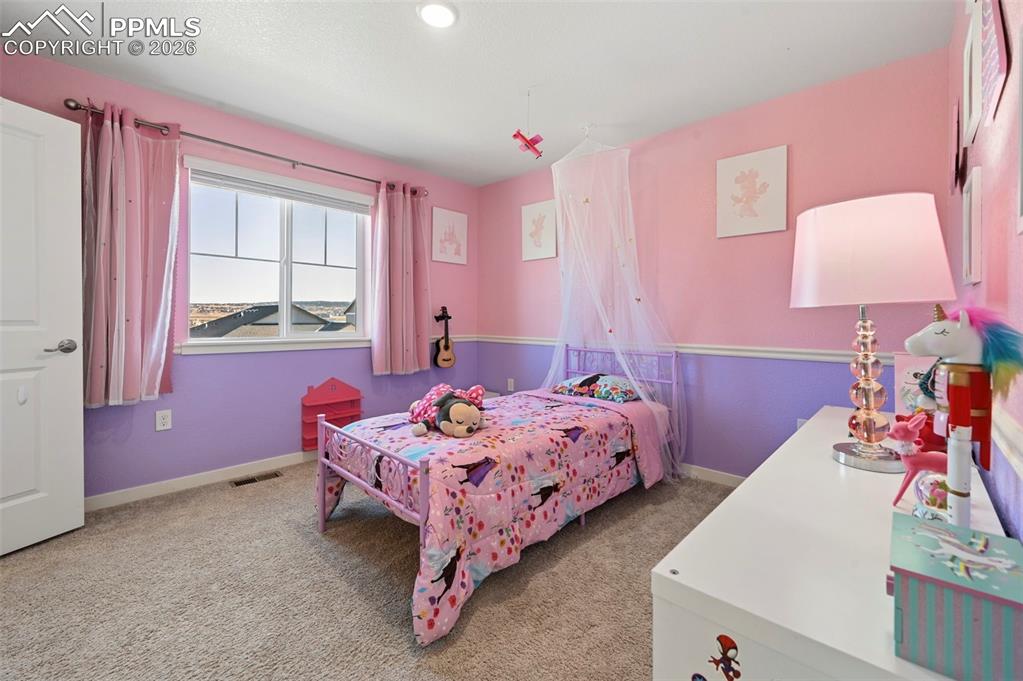 15945 Little Bluestem Road Monument, CO 80132 - Photo 17 of 49 a bedroom with a bed and a dresser