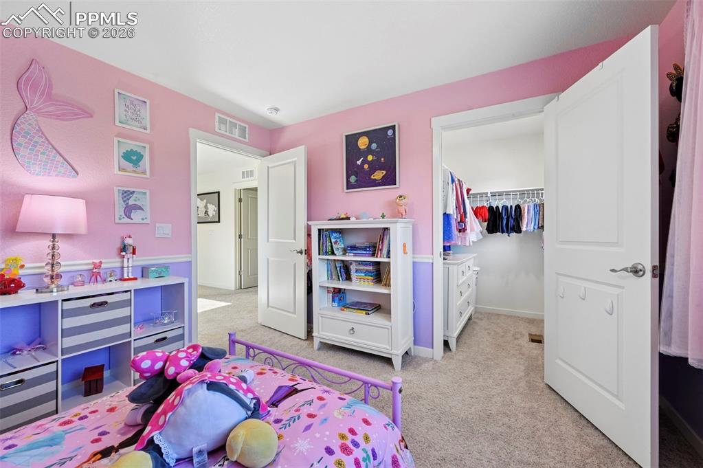 15945 Little Bluestem Road Monument, CO 80132 - Photo 18 of 49 a bedroom with furniture and a dresser