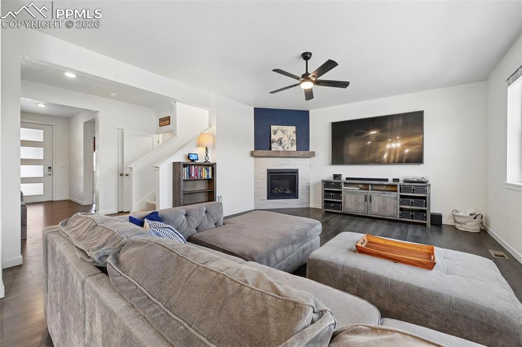 15945 Little Bluestem Road Monument, CO 80132 - Photo 2 of 49 a living room with furniture and a flat screen tv