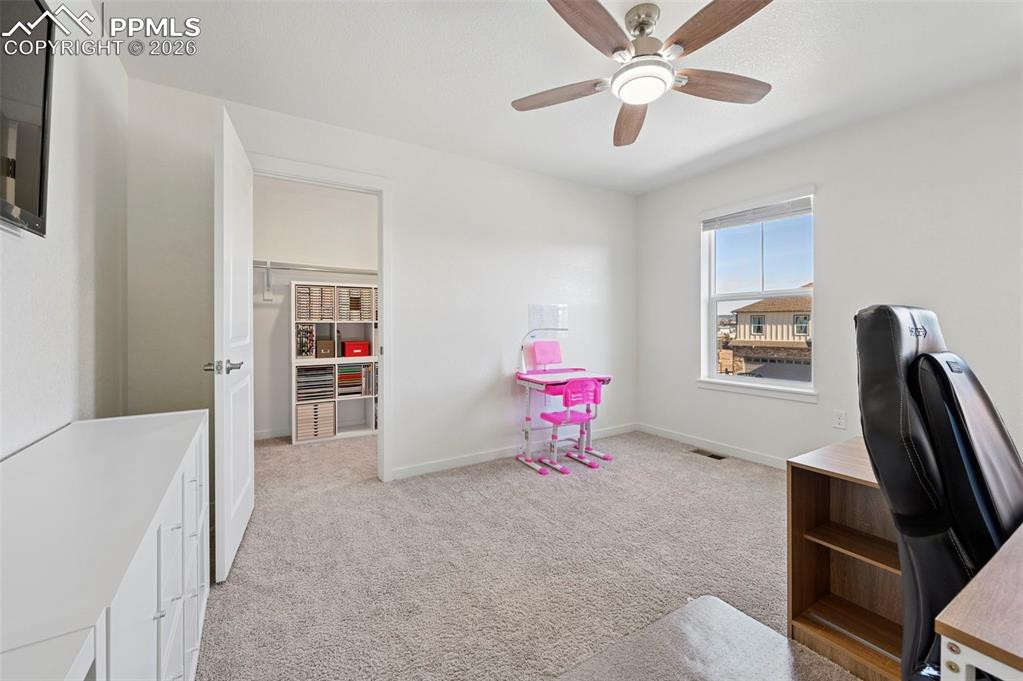 15945 Little Bluestem Road Monument, CO 80132 - Photo 25 of 49 a bedroom with furniture and a window