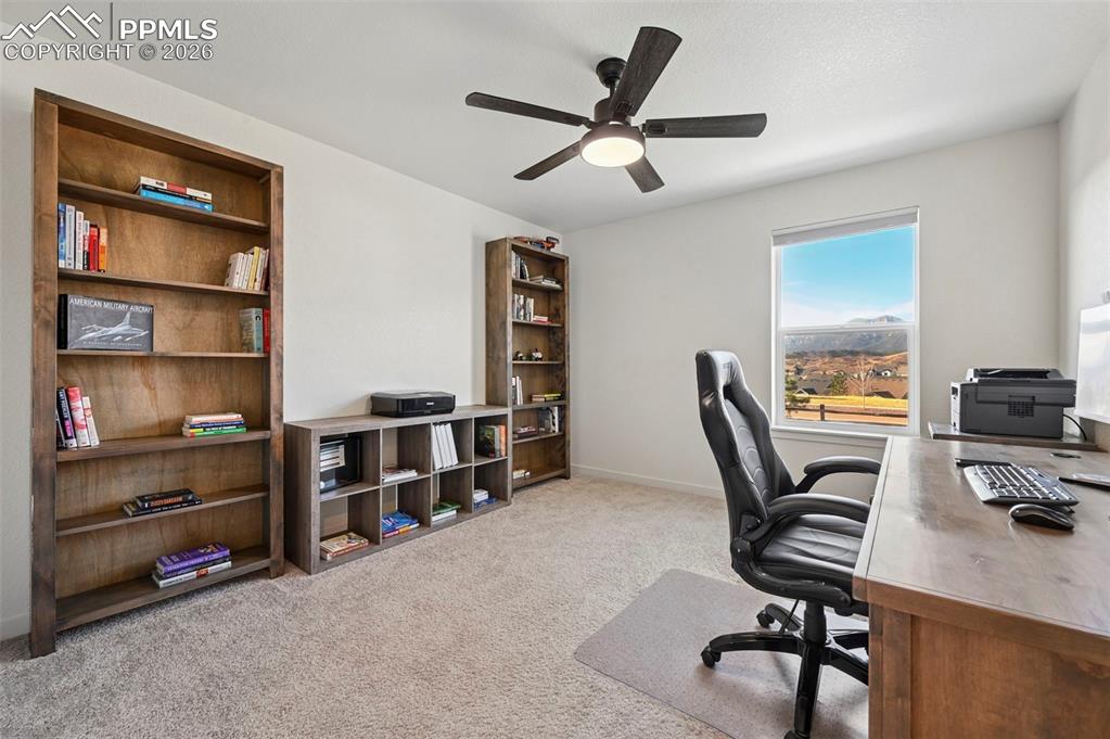 15945 Little Bluestem Road Monument, CO 80132 - Photo 27 of 49 a view of a workspace with furniture and a window